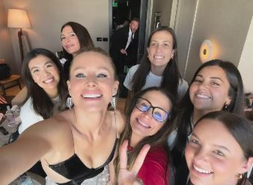 Kristen Bell posing for a selfie with six other women.