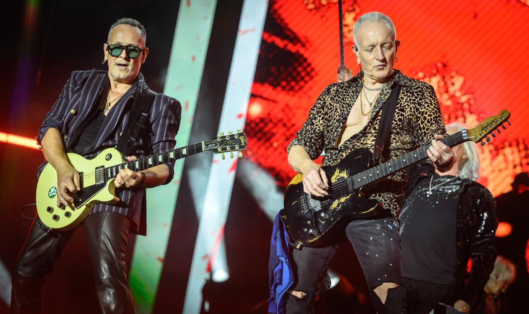 Vivian Campbell and Phil Collen of Def Leppard performing onstage.
