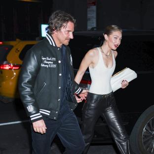 Bradley Cooper and Gigi Hadid holding hands.
