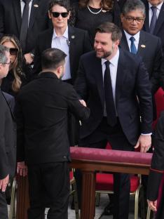 JD Vance shaking hands with another man at Pope Leo XIV's inauguration.