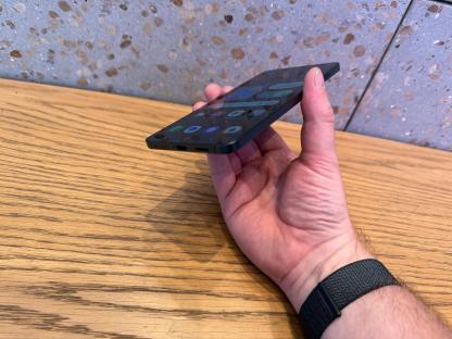A hand holding a smartphone.
