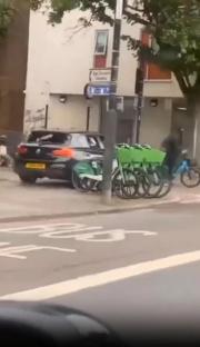 A street brawl breaks out as a driver runs over a cyclist.
