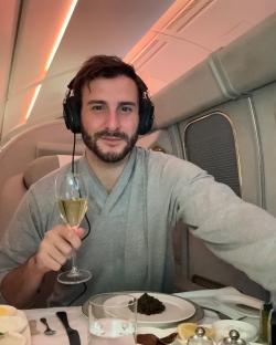 Man on private jet enjoying champagne and caviar.