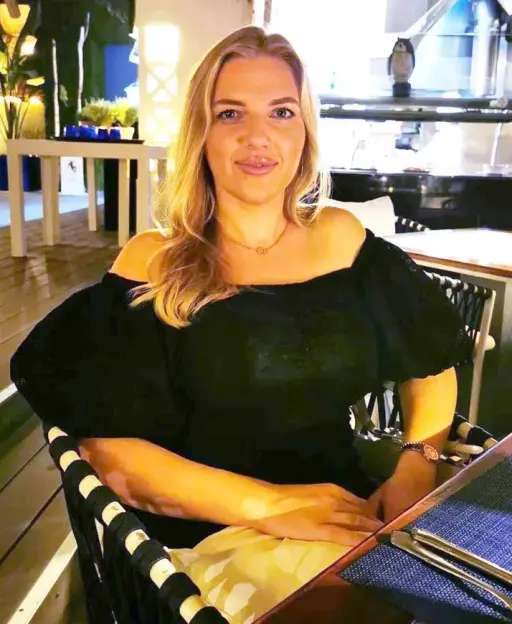 Woman sitting at an outdoor restaurant.