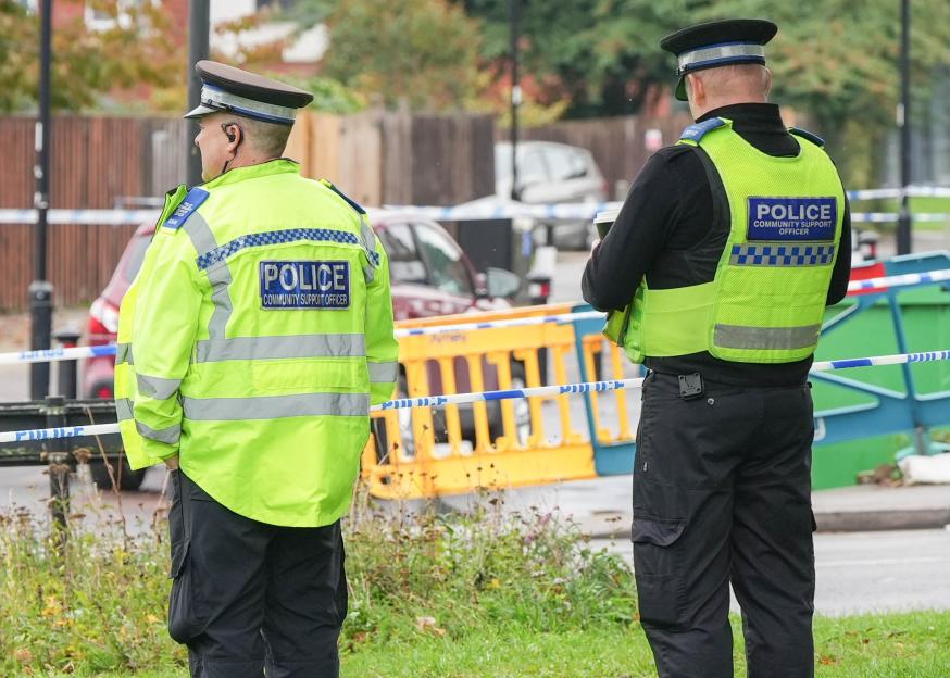 Two police community support officers at a crime scene.