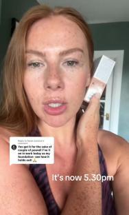 Woman holding foundation and reviewing its wear.