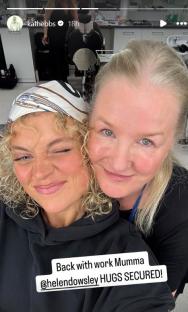 Photo of two women hugging; one is wearing a headscarf.