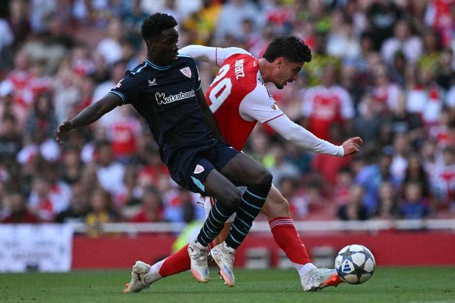 Kai Havertz of Arsenal scoring past Adama Boiro of Athletic Bilbao during a soccer match.