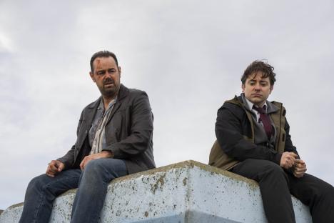 Still from Mr Bigstuff season two, showing Lee and Glen sitting on a wall.
