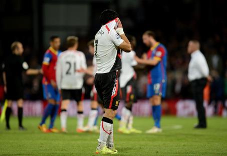 Dejected Luis Suarez of Liverpool reacts after a soccer match.