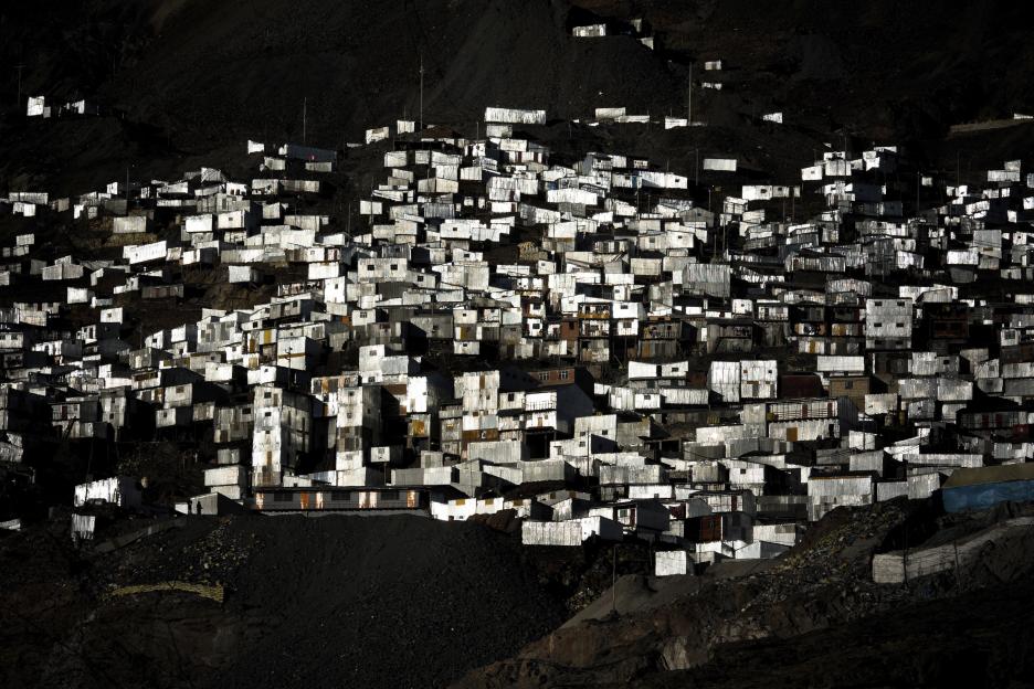 Corrugated metal shacks on a steep mountainside in La Rinconada, Peru.