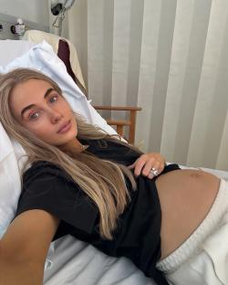 Pregnant woman lying in a hospital bed.
