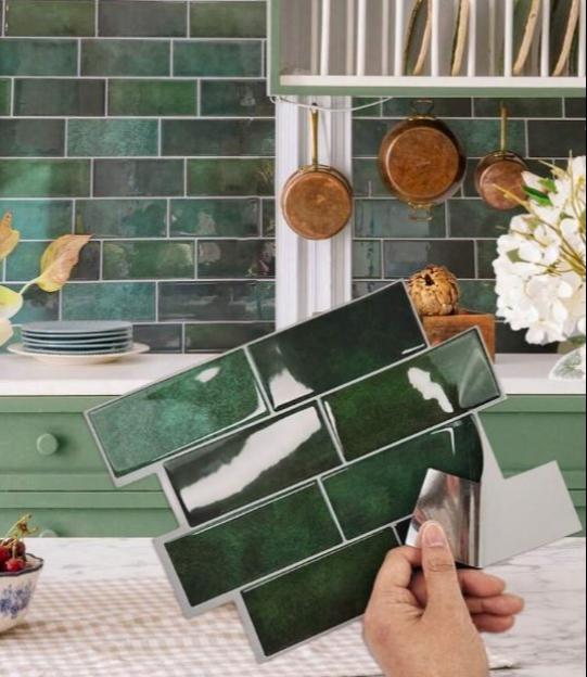 Green self-adhesive brick pattern wall tiles being applied to a kitchen backsplash.