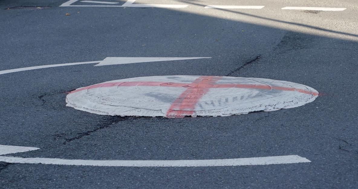 Round traffic calming feature on a road.
