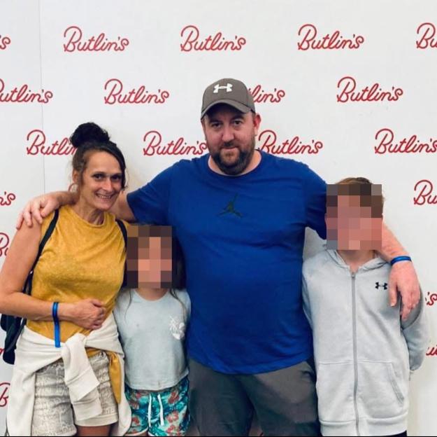 Photo of a family: a man, woman, and two children.