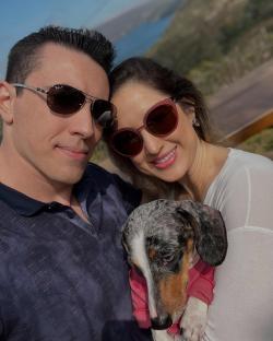 Couple and dog outdoors.