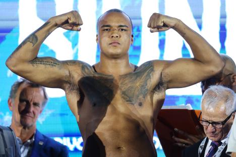 Fabio Wardley flexing his biceps at a weigh-in.