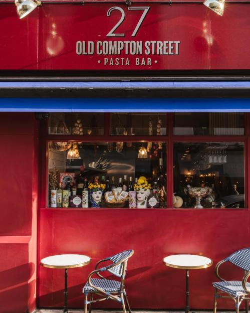 A red storefront with "27 Old Compton Street, Pasta Bar" written above a blue awning.