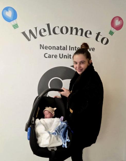 Megan Isherwood leaving the Neonatal Intensive Care Unit with her baby Jackson in a car seat.