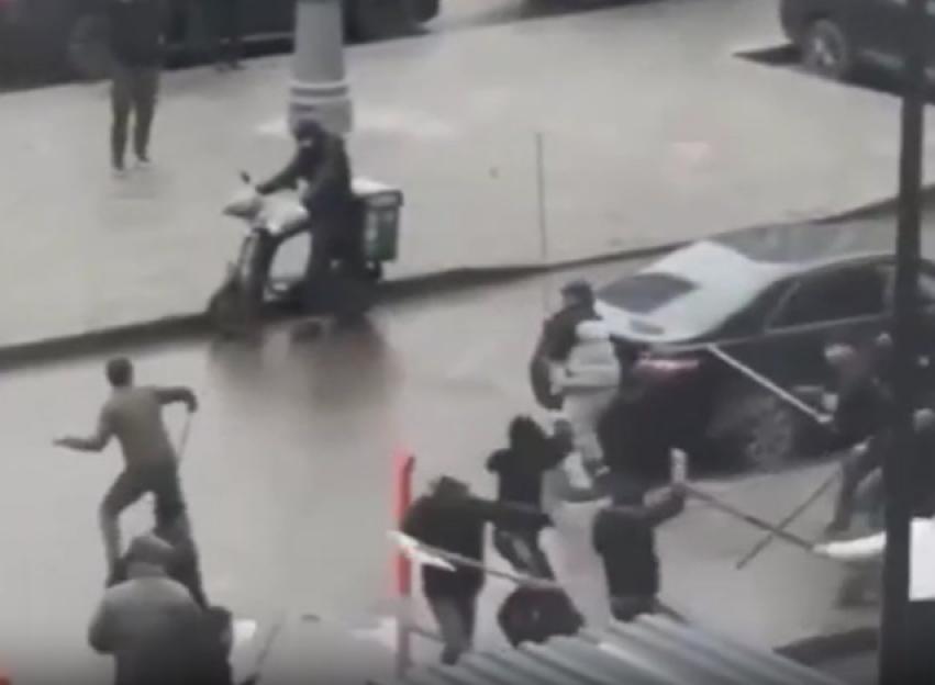 A group of men fighting in the street.