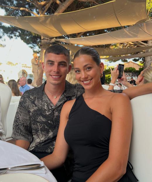 Couple sitting together at an outdoor restaurant.