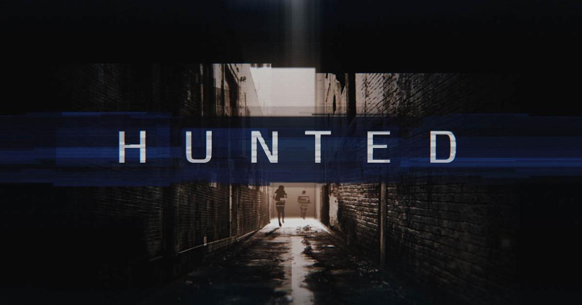 HUNTED logo on a dark alleyway with two figures walking away from the viewer.