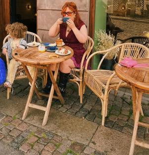 Woman and child at an outdoor cafe.
