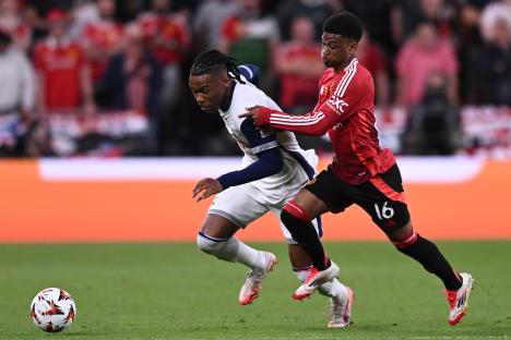 Destiny Udogie of Tottenham competing for the ball with Amad Diallo of Manchester United.