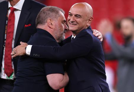 Daniel Levy and Ange Postecoglou embracing after a soccer match.