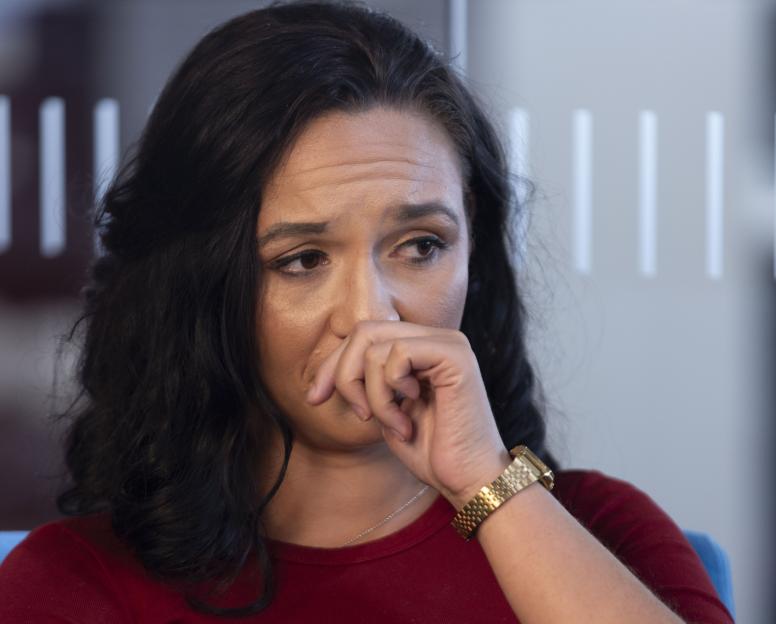 Charlotte Chilton looks down with her hand covering her mouth during an interview with Amanda Devlin.