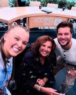 JoJo Siwa, Chris Hughes, and another woman posing for a selfie at the Access Daily set.