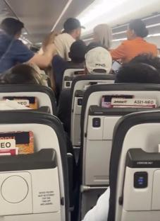 Passengers fighting on an airplane.
