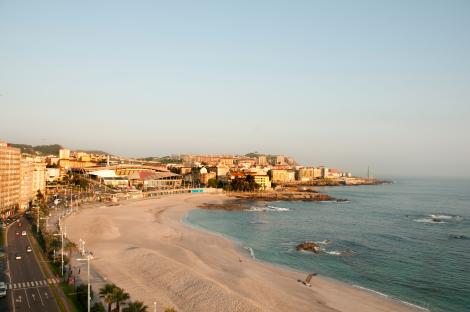 A Coruña, Spain beach and cityscape.