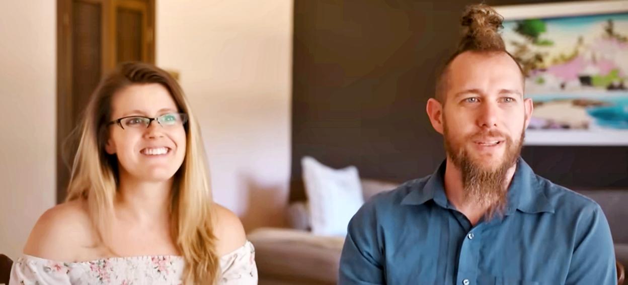 Couple smiling at the camera.