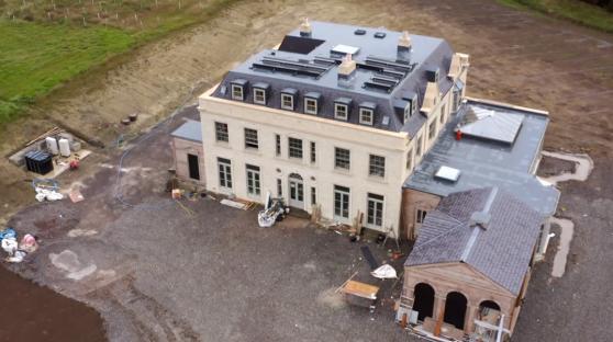 Aerial view of a large house under construction.