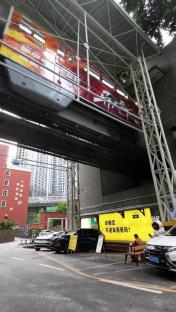 Train passing over street-level buildings.