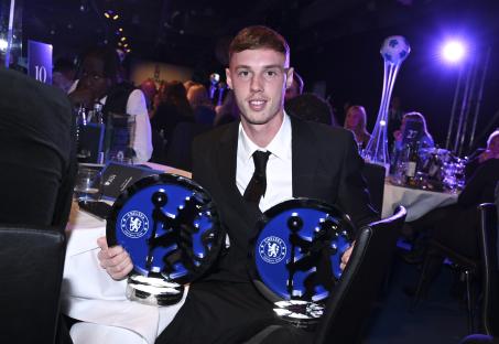Cole Palmer holding two Chelsea Football Club awards.