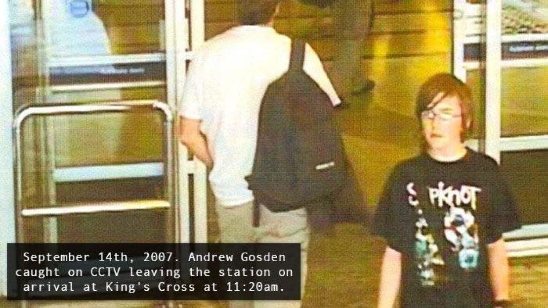 CCTV image of Andrew Gosden at King's Cross station, wearing a black t-shirt and glasses.