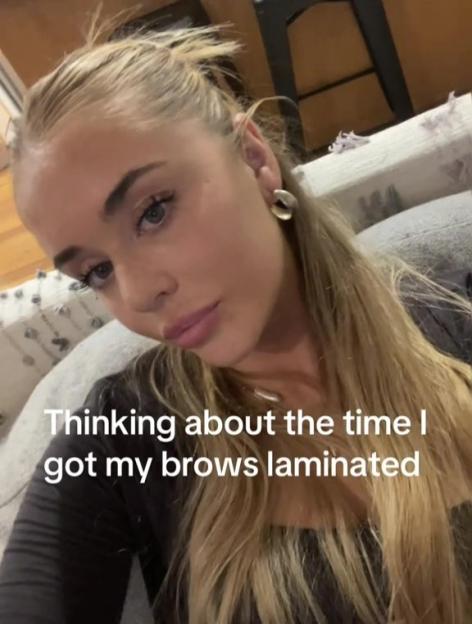 Woman reflecting on eyebrow lamination.