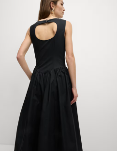 Model wearing a black midi dress with a keyhole back.