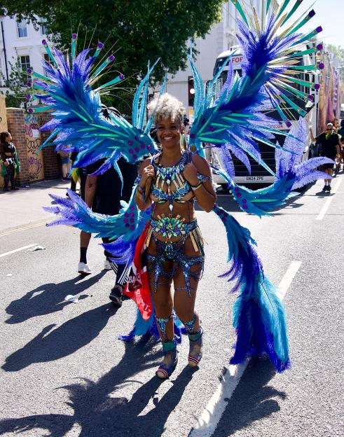 Reveller in elaborate blue costume at Notting Hill Carnival.
