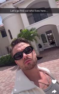 a man wearing sunglasses stands in front of a large white house with the caption let 's go find out who lives here
