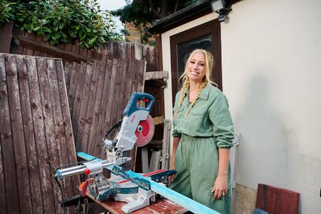 Stacey Solomon standing by a miter saw.