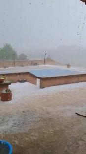 Flooded patio with hail during a storm in Spain.