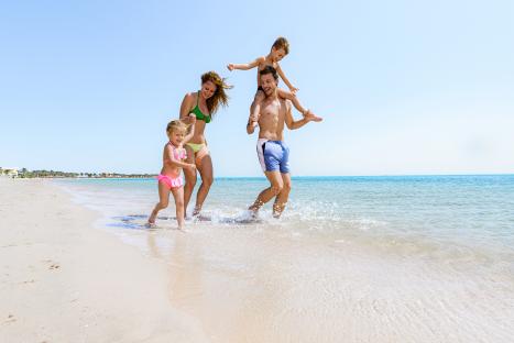 Family playing on a beach.