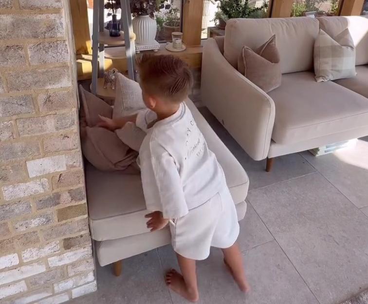 Young boy playing in sunroom.