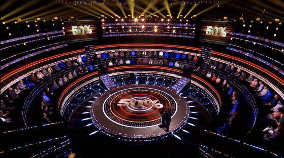 Game show set with audience and host.