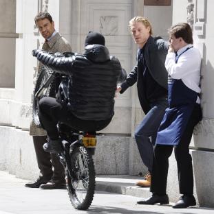 Behind-the-scenes photo of Vinnie Jones and Theo James filming a scene.