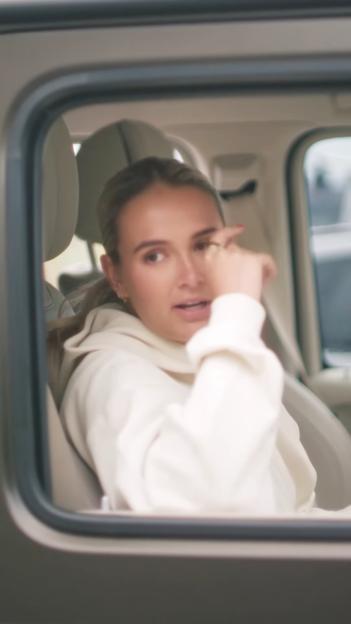 Molly-Mae Hague looking upset in a car.