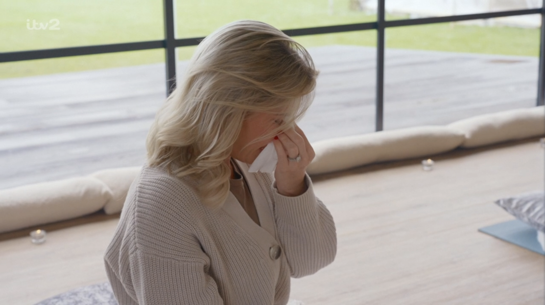 Woman crying while holding a tissue.